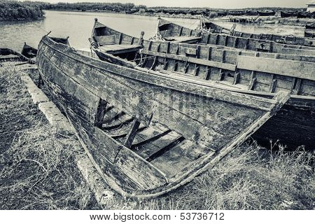 Old fishing boats stranded on the Jurilovca shore, near Danube Delta