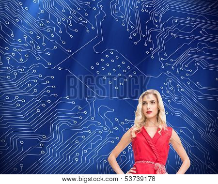 Composite image of elegant blonde standing hands on hips in red dress