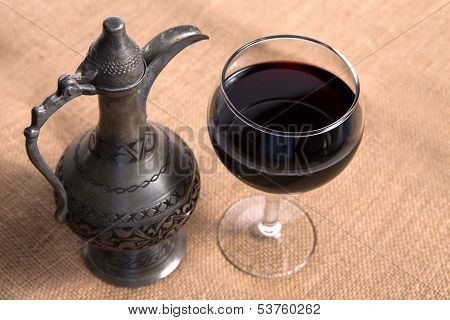 Simple View Of Pewter Flagon And Red Vine In The Glass