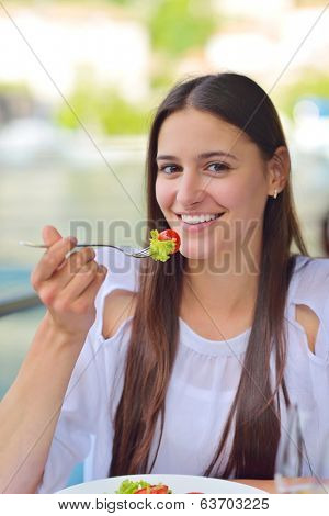 happy young couple having lanch at beautiful restaurant on by the sea on  beach
