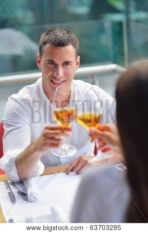 happy young couple having lanch at beautiful restaurant on by the sea on  beach