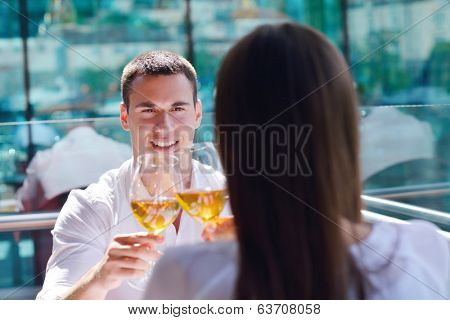 happy young couple having lanch at beautiful restaurant on by the sea on  beach