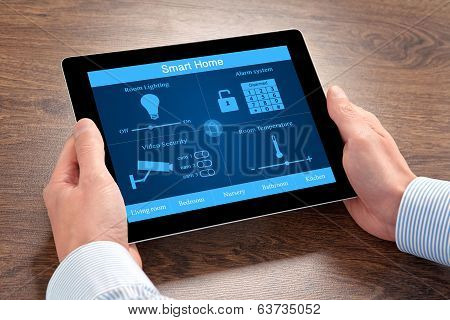 Businessman Holding A Tablet Computer With System Smart House