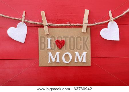 Mothers Day Message With Clothespins Over Red Wooden Board