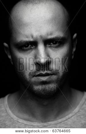 Vertical portrait of spiteful man looking at camera