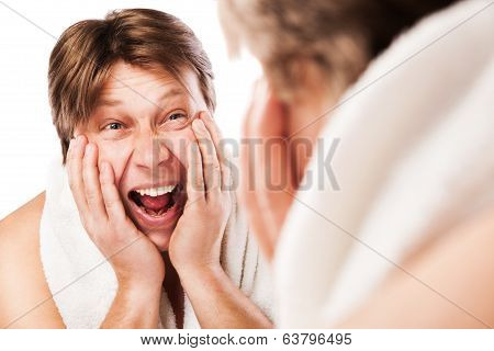 Screeming Man applying moisturizing lotion after shaving for his face