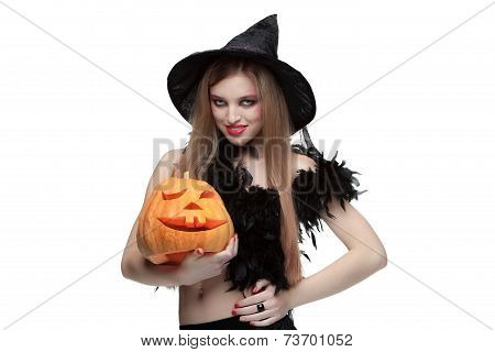 Girl in witch costume with Halloween pumpkin