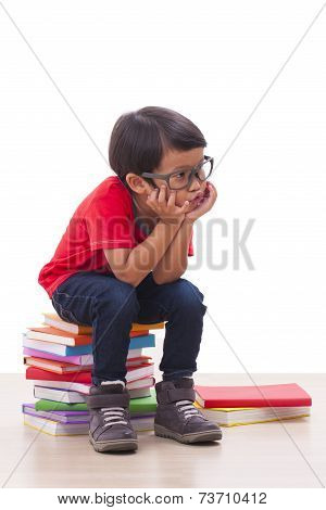 boy sitting on books