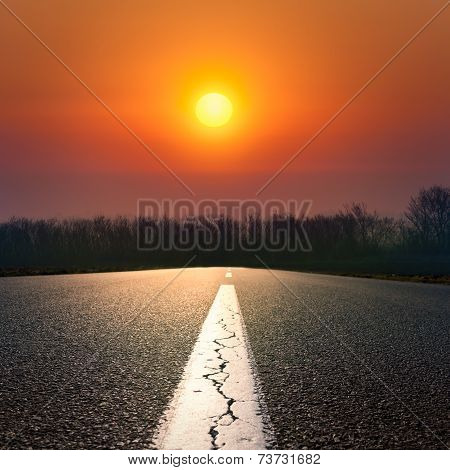 Driving On An Empty Road At Sunset