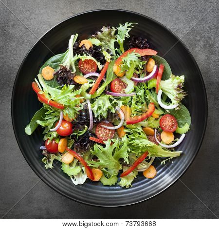 Garden salad in black bowl.  Overhead view.