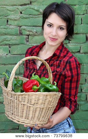 Young woman with a basket of peppers
