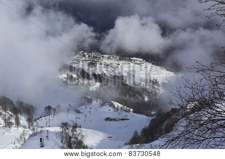 Hotels of Roza Khutor plateau in clouds.