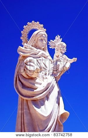 White marble statue of mother and child.