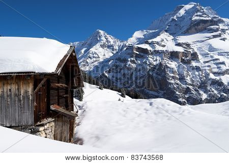 Old farmhouse in front of the Jungfrau in the Winter
