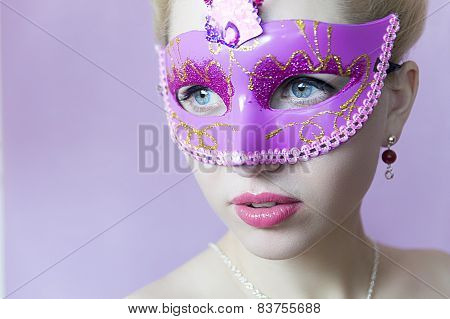 Woman in pink carnival mask