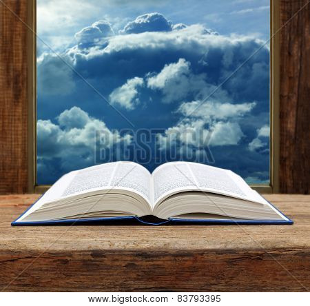 Bible open book wooden window sky view stormy cloud
