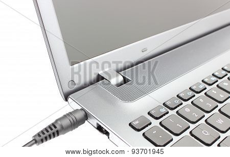 Plug Adapter Being Connected To Laptop Computer
