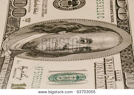 One hundred dollar bill lying vertically