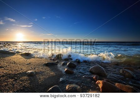Sunset Over The Baltic Sea. The Pebbly Beach In Rozewie