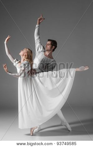 Two young ballet dancers practicing. attractive dancing performers  in white