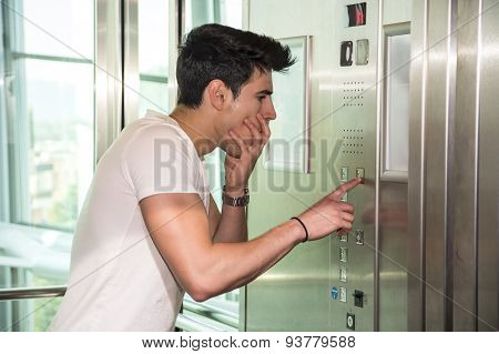 Scared young man desperate in stuck elevator