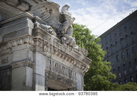 NEW YORK - MAY 25 2015: An eagle and words In Memoriam carved into the Soldiers and Sailors Monument with a wreath in the foreground at the Memorial Day Observance service during Fleet Week NY 2015.