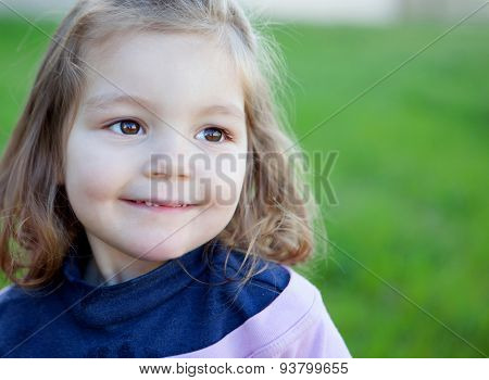 Cute little girl with a beautiful smil in the park