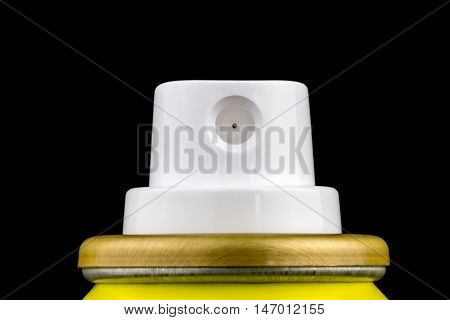 Aerosol spray can nozzle isolated against a black background