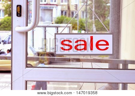 A sign with red letters on the front door