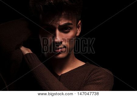 male beauty portrait of young man holding hand behind head and on shoulder