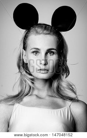 Blonde girl wearing bodysuit and black mouse ears, black and white photo