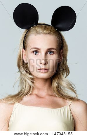Blonde girl wearing bodysuit and black mouse ears