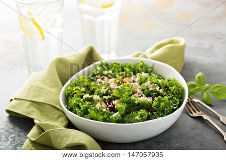 Fresh healthy salad with kale, almond, cranberry and quinoa