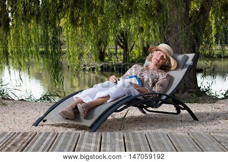 Elders woman sleeping in a lounge chair