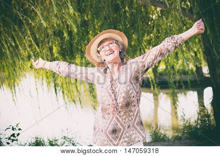 Elder happy woman outside in the nature