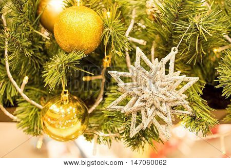 close up beautiful gold star and gold ball decorated on Chirstmas tree