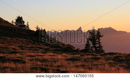 Summer evening on Mt Niederhorn Swiss Alps. Silhouette of Mt Stockhorn.