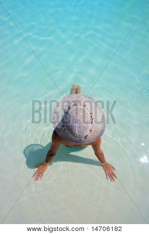 Beautiful young woman at a pool of a luxurious hotel