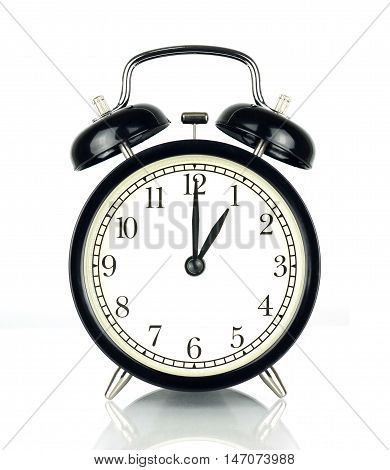Alarm Clock isolated on white in black and white showing one o'clock.
