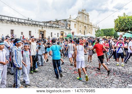 Antigua Guatemala - September 14 2015: Locals run with lit torches in front of cathedral during Guatemalan Independence Day celebrations