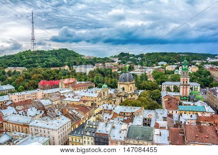 Lviv Ukraine old city vintage toned top view panorama with houses roofs. High Castle park Dominican Church Korniakt Tower Dormition Assumption church television tower