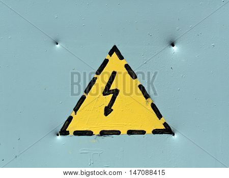 Electric Emergency Warning Sign On Grey Metal Sureface.