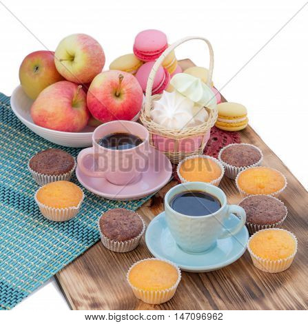 Still life of served coffee cups macaroon cookies marshmallows and apples