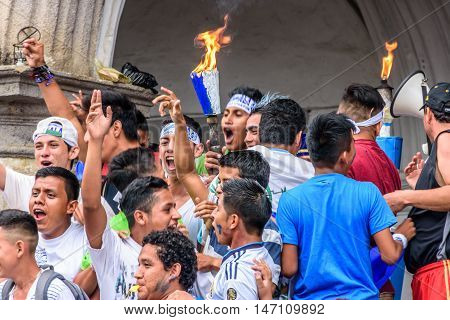 Antigua Guatemala - September 14 2015: Locals cheer with lit torches outside city hall during Guatemalan Independence Day celebrations