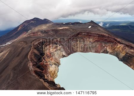 Maly Semyachik is a stratovolcano with acidic crater lake. Kronotsky Nature Reserve on Kamchatka Peninsula. View from helicopter.