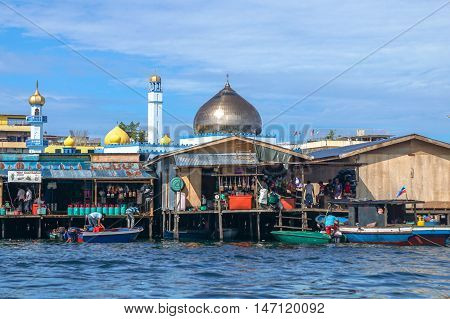 Semporna,Sabah-Sept 10,2016:Semporna bajau traditional water village with background of Ar Rahman Mosque Semporna is a popular tourist attraction at Semporna,Sabah,Borneo,Malaysia.