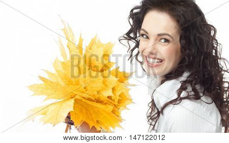 portrait of attractive  caucasian smiling woman brunette isolated on white studio shot hand holding yellow marple autumn leaves