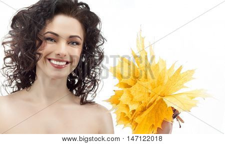 portrait of attractive  caucasian smiling woman brunette isolated on white studio shot head and shoulders face shin hair hand holding yellow marple autumn leaves