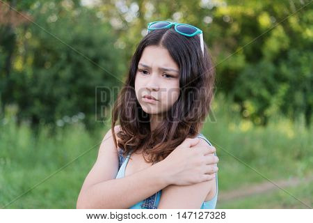 teen girl with health problems in the nature in summer