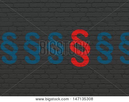 Law concept: row of Painted blue paragraph icons around red paragraph icon on Black Brick wall background